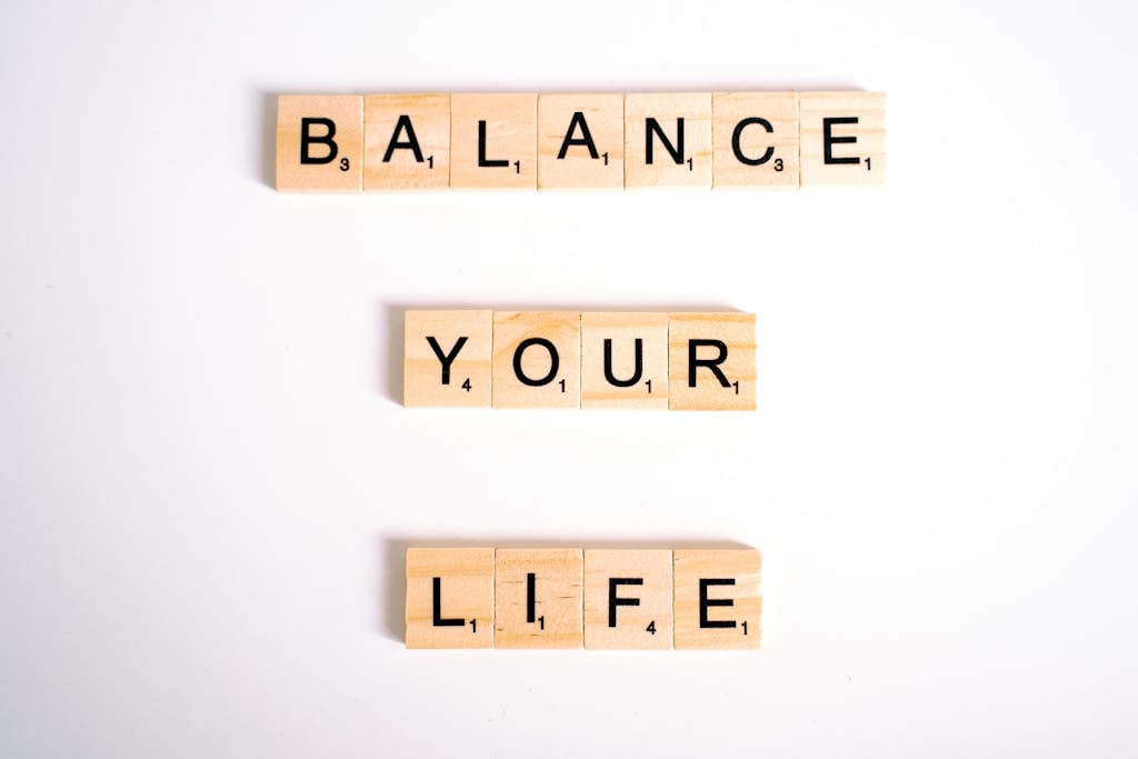 Inspirational message 'Balance Your Life' made with Scrabble tiles on a white background.